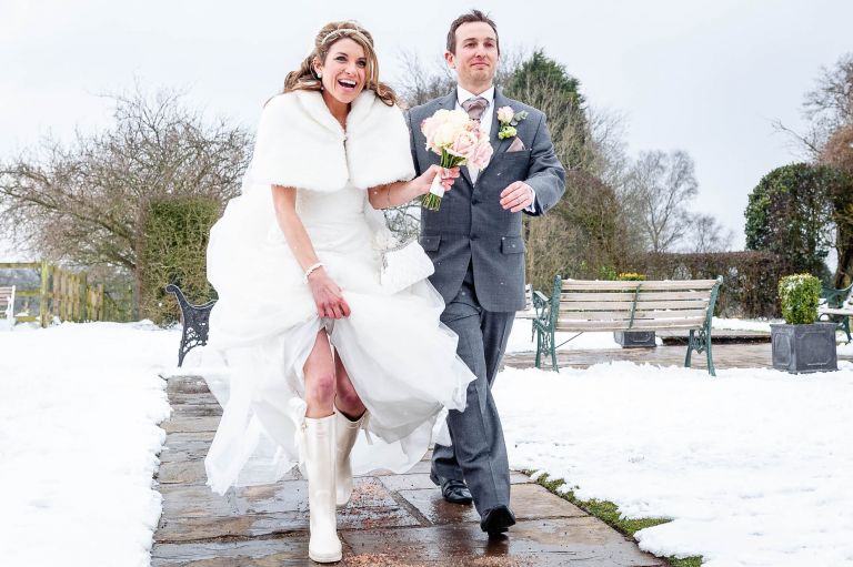 Bride and groom walk into wedding breakfast