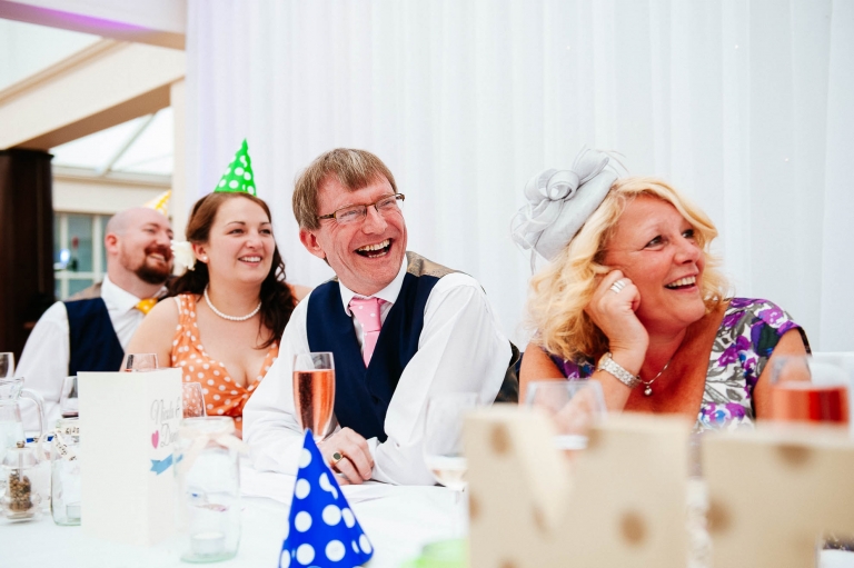 Father of the bride tells a joke during the speeches
