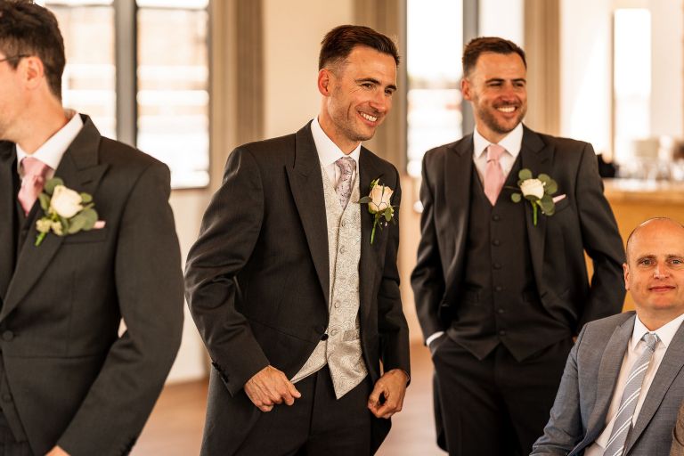 Groom shares a joke with his groomsmen