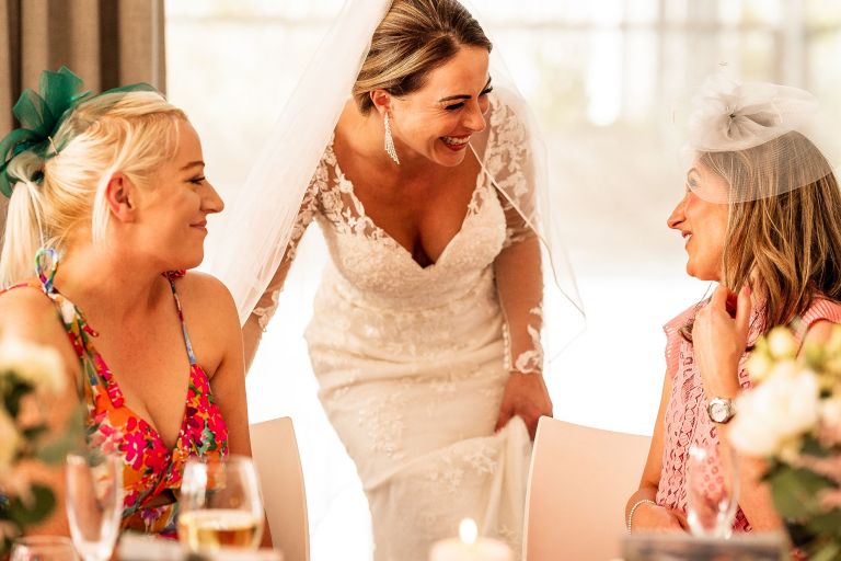 Bride shares a joke with wedding guests