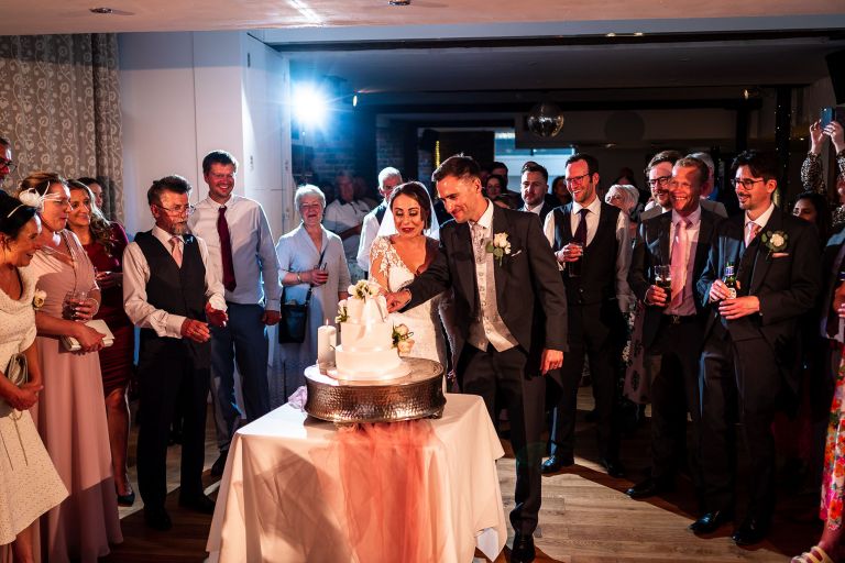 Bride and groom cut the cake