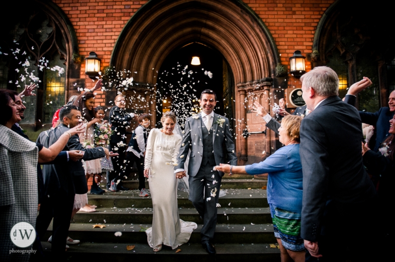 Bride and groom showered with confetti