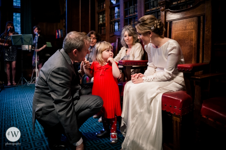 Little girl talking to the bride