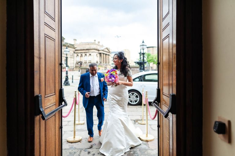 The bride arrives at St Georges Hall with her father