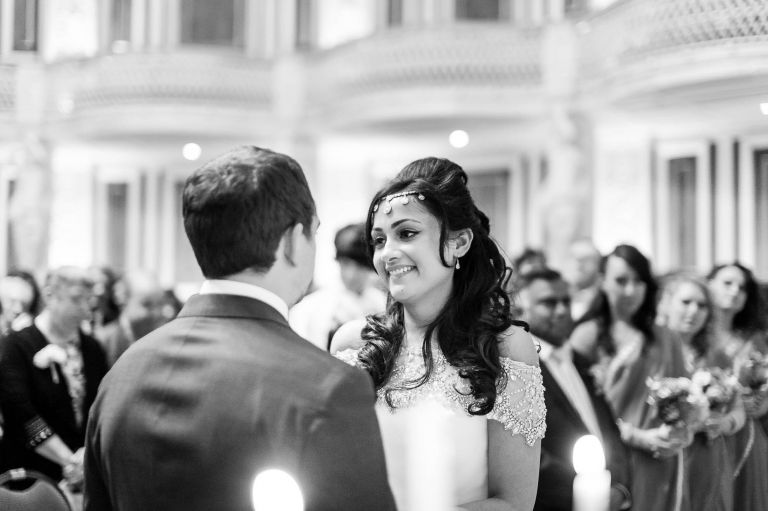 Bride smiles at the groom during speeches