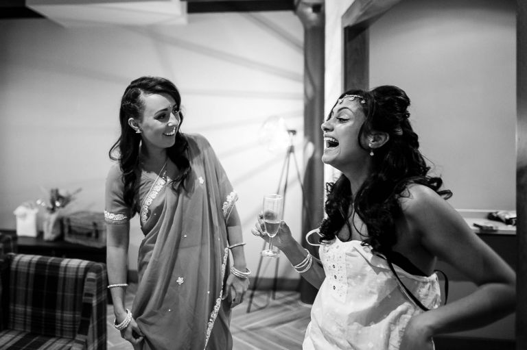 Bride shares a joke with bridesmaids