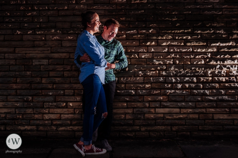 Couple leaning against a wall