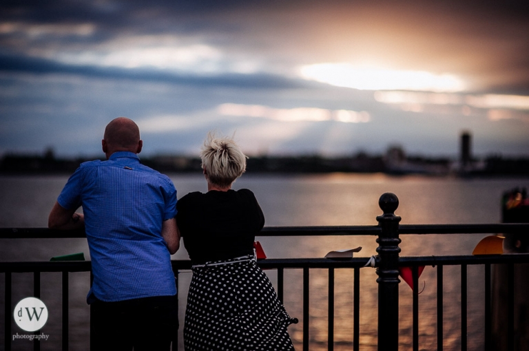 Couple looking out over the Mersey sunset