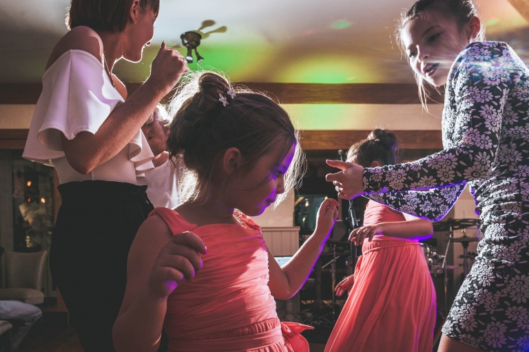 Flower girl dancing with guests