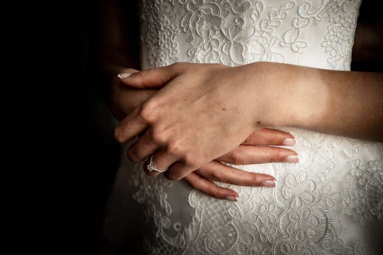 Close up of brides hands and engagement ring