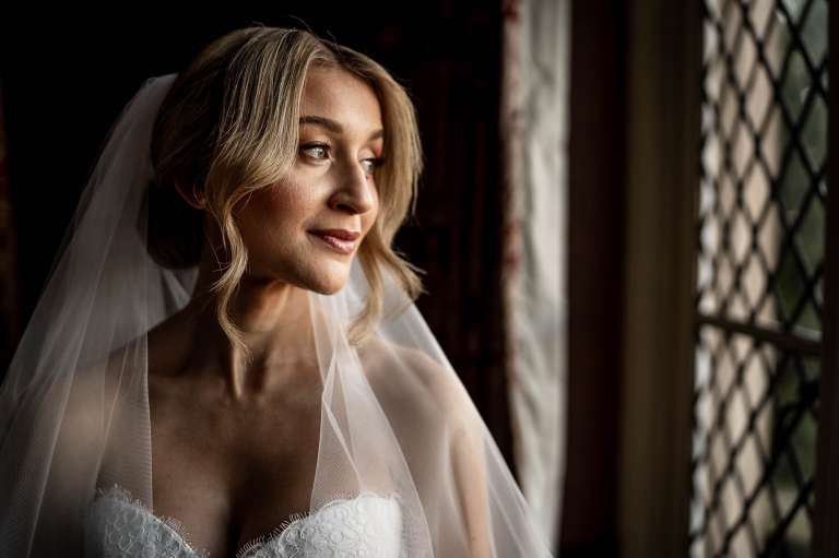 Portrait of bride looking out of the window