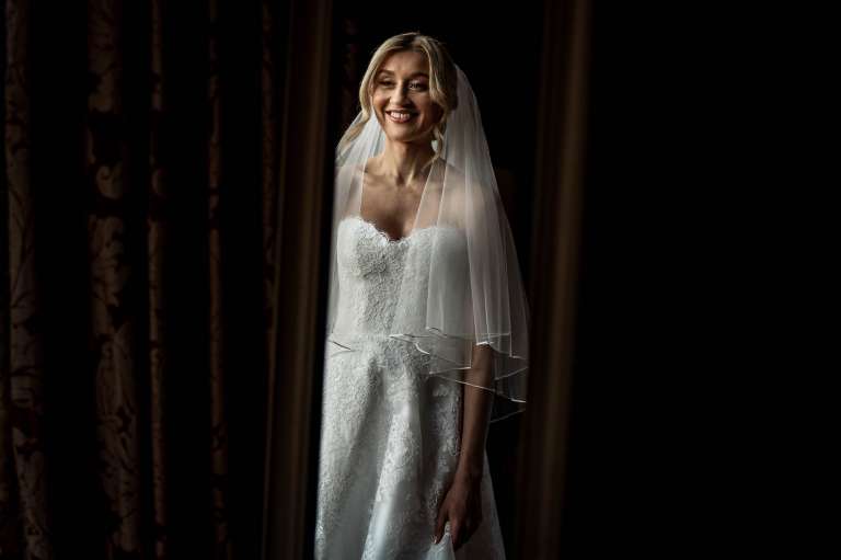 Bride smiling as she looks into the mirror