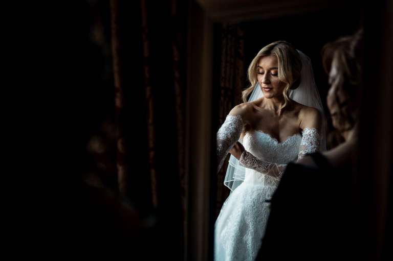 Bride putting on her lace gloves