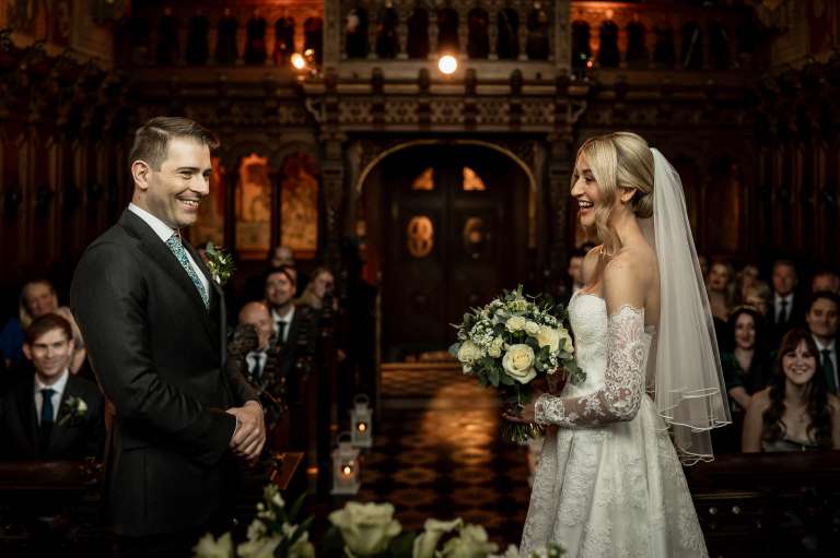 Bride and groom share a joke during the exchange of vows