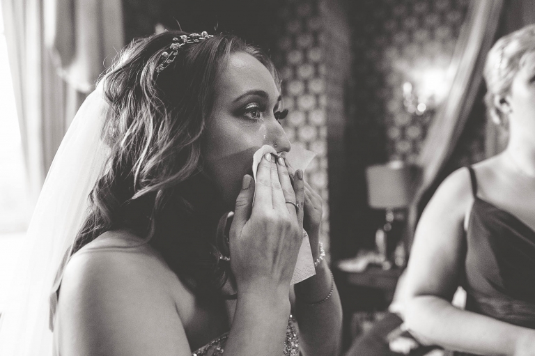 Bride wipes away a tear