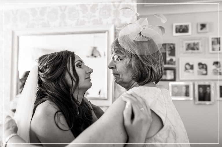 Bride and her mum look into each others eyes 