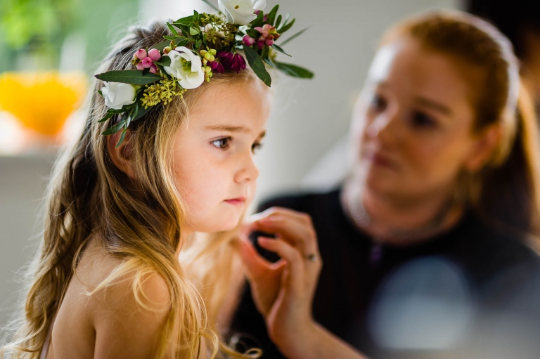 A flower girl has her flower garland fitted