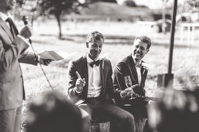 Groom laughing at guests speech