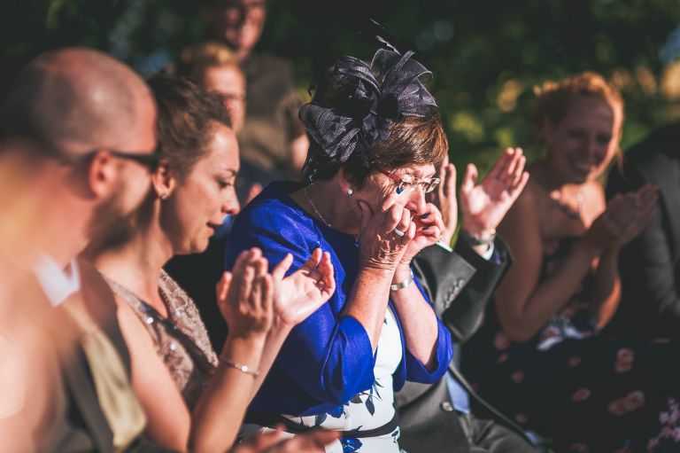 Mother of the groom wipes away tears
