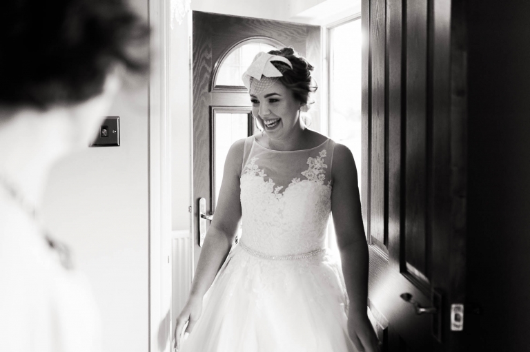 Bride enters the living room to show everyone her dress