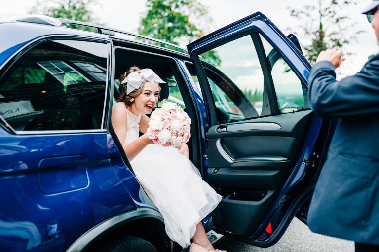 Bride steps out of the wedding car