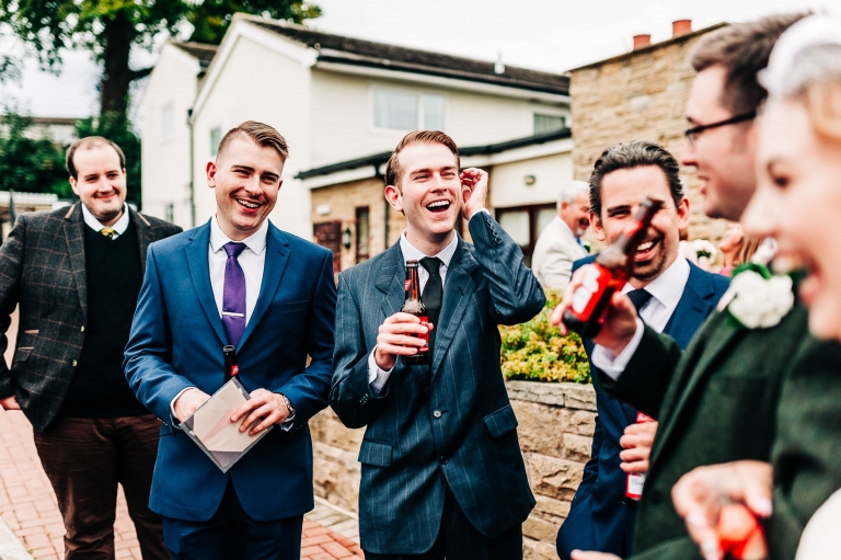Wedding guests share a joke with the happy couple