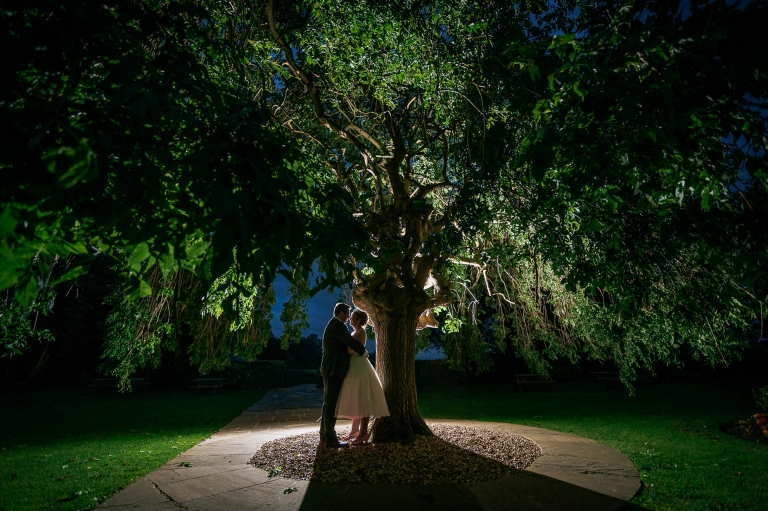 Bride and groom portrait under a tree