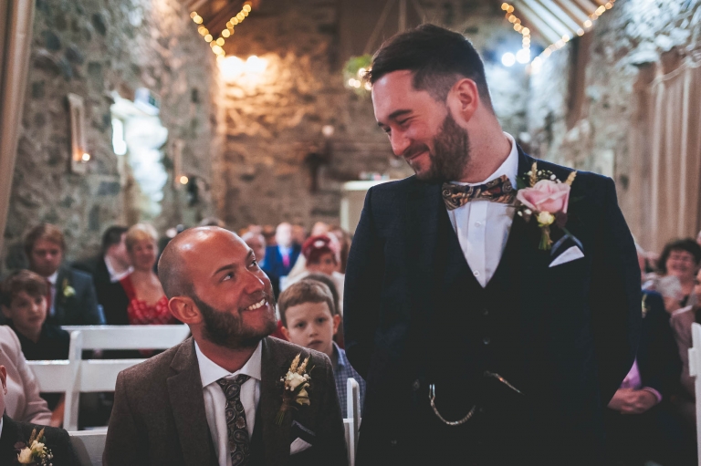 groom and best man share a joke