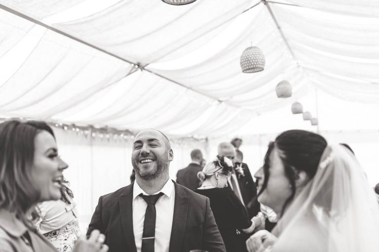 Bride shares a joke with guests