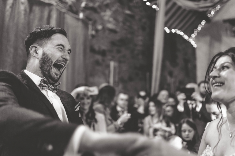 Groom laughs during first dance