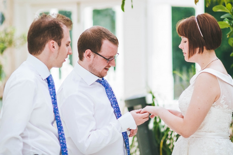 Best man looks at brides ring