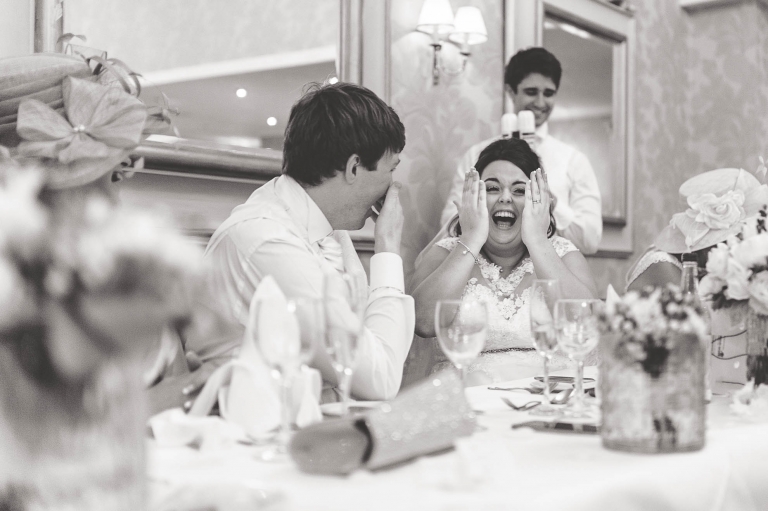 Bride and groom laugh at best mans speech