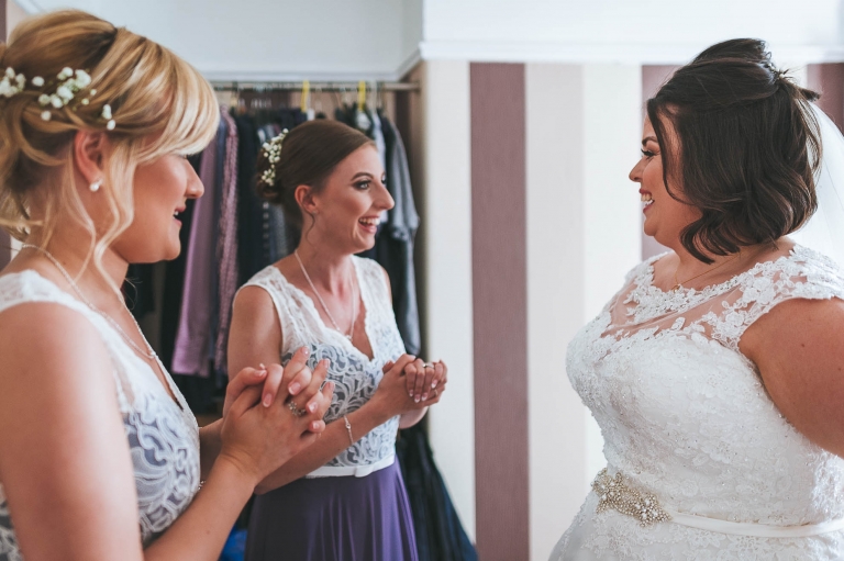 Bride sharing a joke with bridesmaids