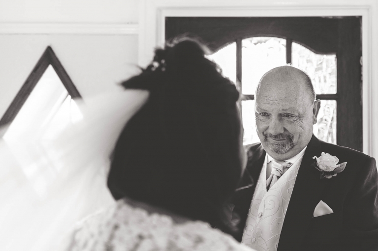 Father of the bride sees the bride in her dress for the first time