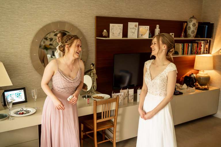 Bride and bridesmaid share a joke