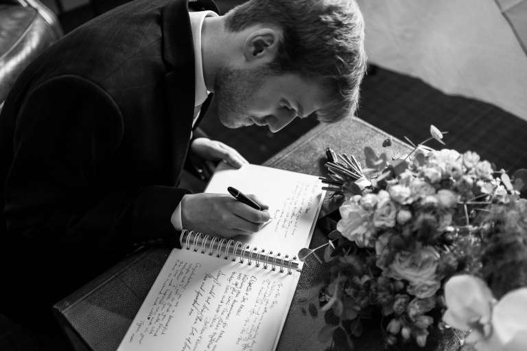 Brother of the bride signs the guest book