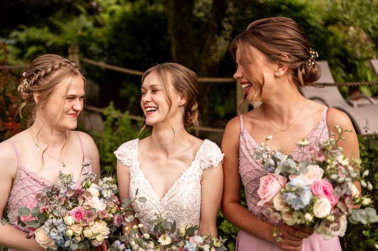 Bride and bridesmaids share a joke