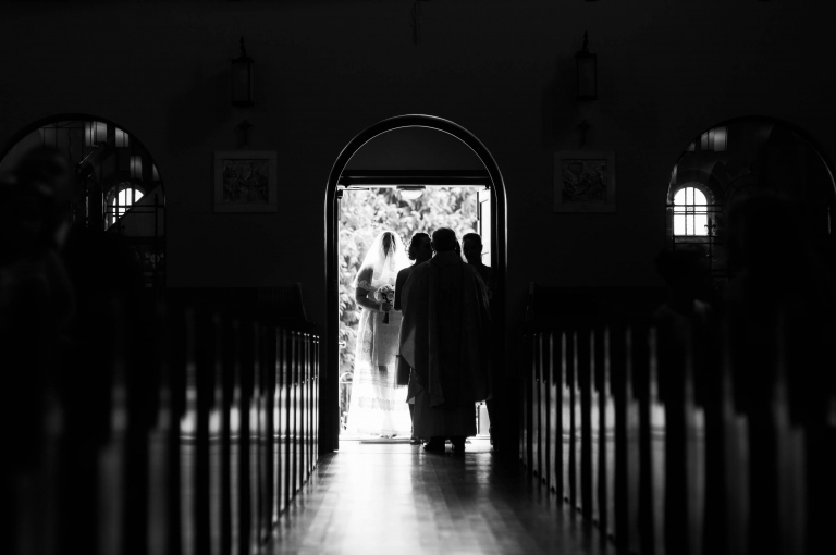 Bride waits with the bridal party at the entrance to the church
