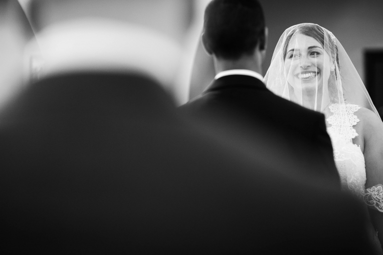 Bride smiles at the groom during the wedding vows
