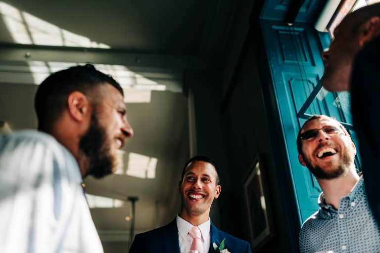 Groom shares a joke with wedding guests