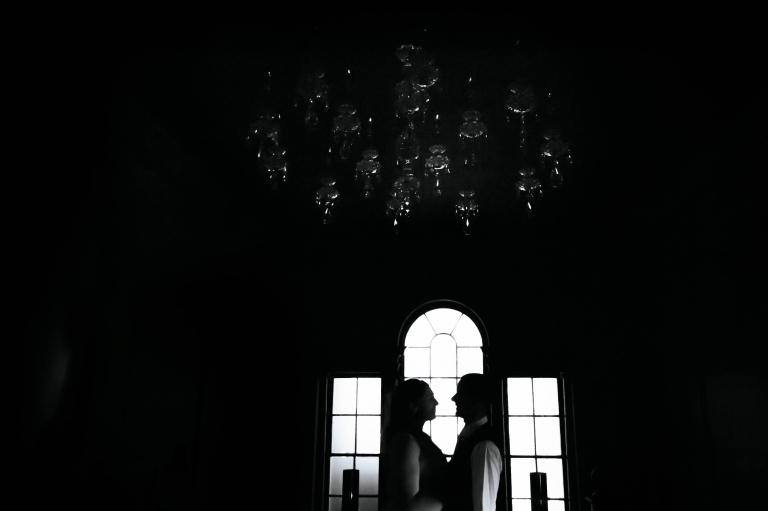 Silhouette of bride and groom in window