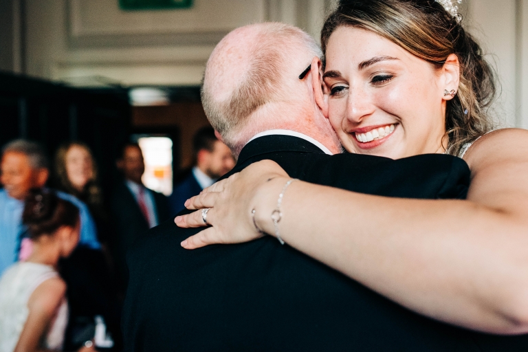 Bride smiles as she dances with her father