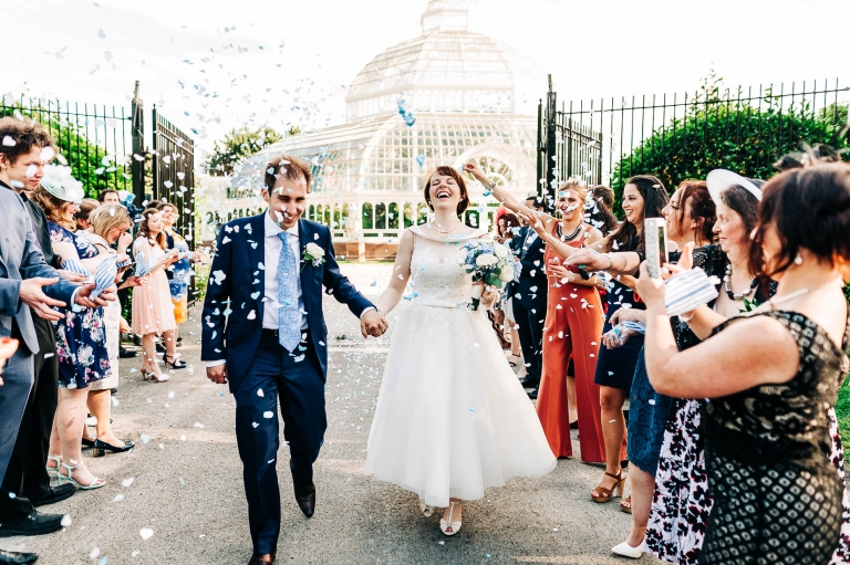 Bride and groom walk through confetti throw