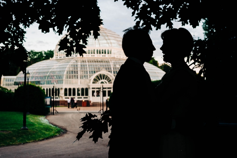 Bride and groom silhouette outside Palm House