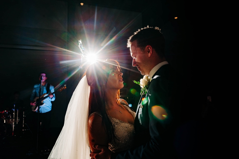 Bride and groom smile during first dance