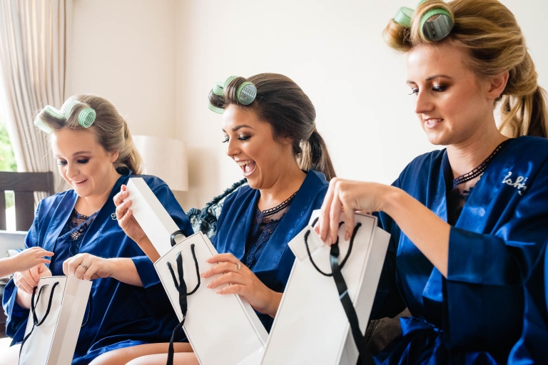 Bridesmaids get excited as they open their presents