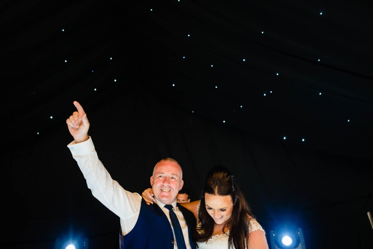 Bride and father of the bride dance together