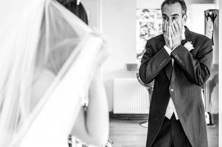 Father of the bride sees the bride in her dress for the first time