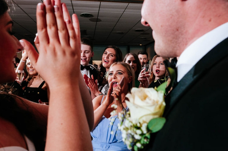 wedding guests applaud bride and groom after first dance