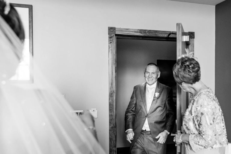 Bride reveals her dress to her father 